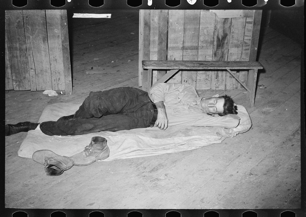Squatters asleep on floor in warehouse, Caruthersville, Missouri by Russell Lee