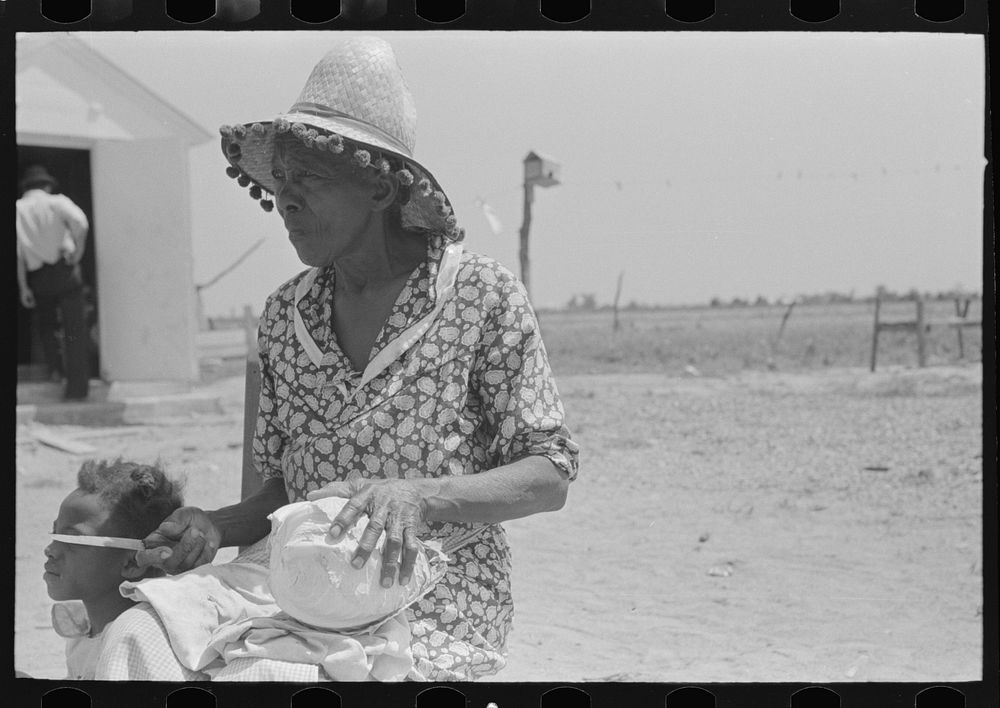 Southeast Missouri Farms. Mother of FSA (Farm Security Administration) client with knife and cabbage head by Russell Lee