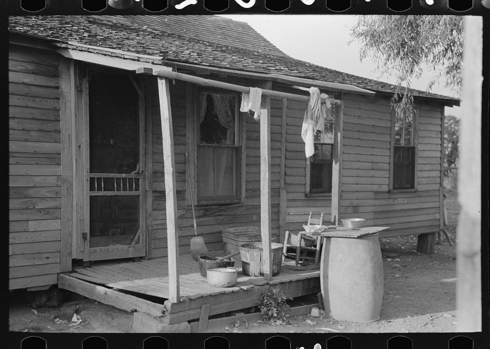 Background photo, rear porch of FSA (Farm Security Administration) client's old home, Caruthersville, Missouri by Russell Lee