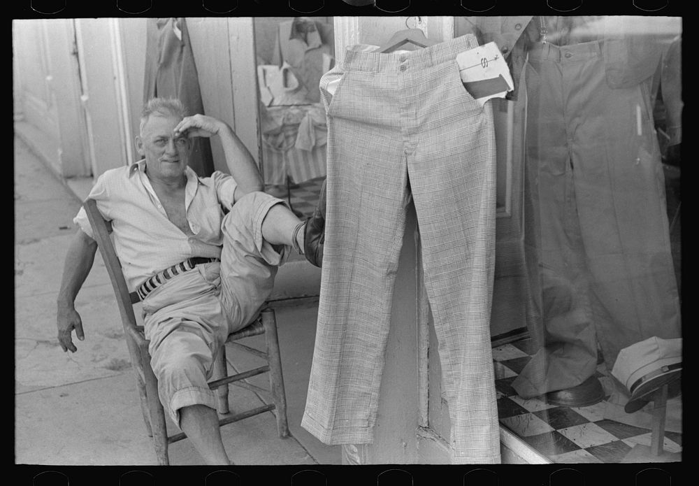 [Untitled photo, possibly related to: Storekeeper in front of men's store, Caruthersville, Missouri] by Russell Lee