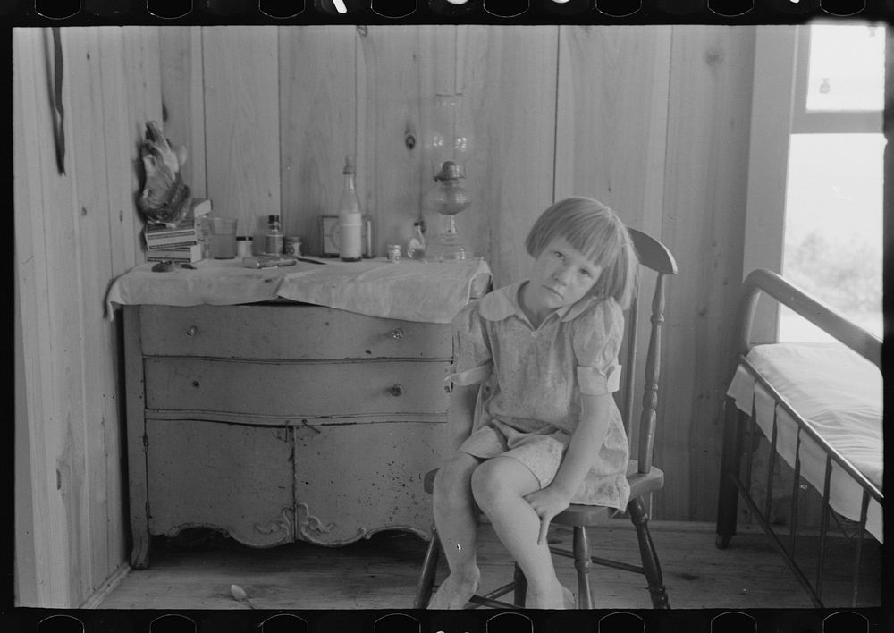 Child of relief worker living in two-room shack home, Caruthersville, Missouri by Russell Lee