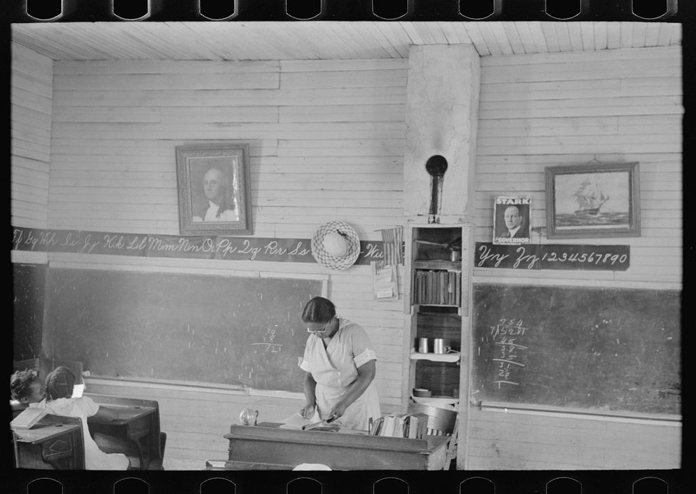 [Untitled photo, possibly related to: Schoolteacher explaining passage to pupil, La Forge, Missouri. School attended by…