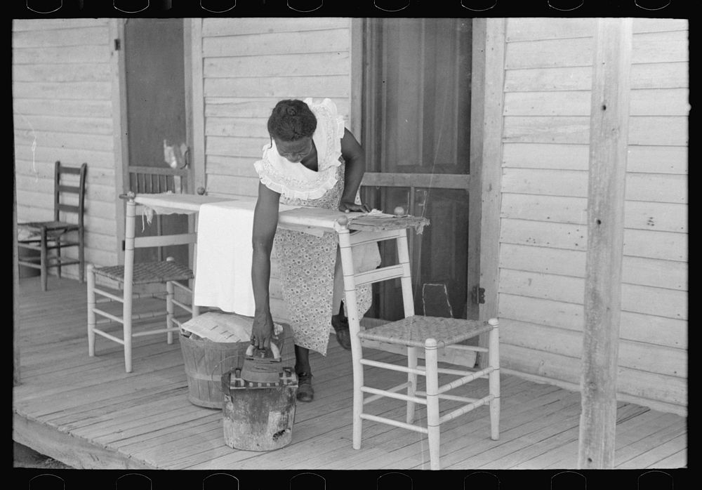Housewife ironing, Caruthersville, Missouri by Russell Lee