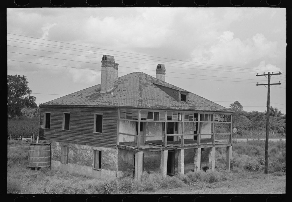 Abandoned plantation home, north of Destrehan, Louisiana. Lower floor is used as stable for cows; at present house is only…