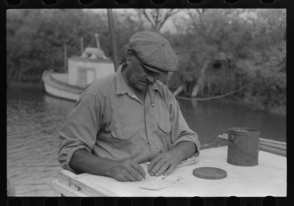 [Untitled photo, possibly related to: Oyster shipper making out tags to be attached to bags of oysters, Olga, Louisiana] by…