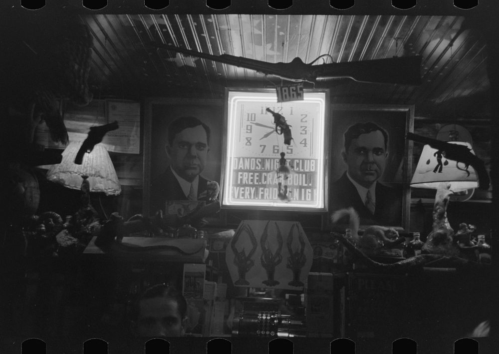 [Untitled photo, possibly related to: Illuminated clock in Raceland, Louisiana, saloon. Note advertisement of crab boil] by…