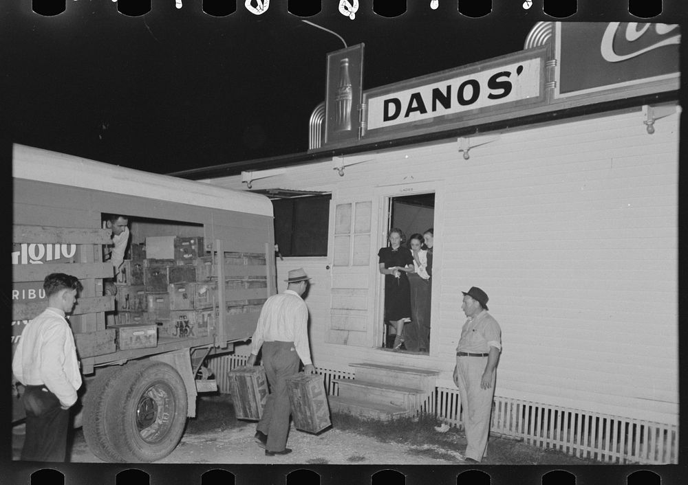Helper carrying beer from truck into nightclub, Raceland, Louisiana by Russell Lee