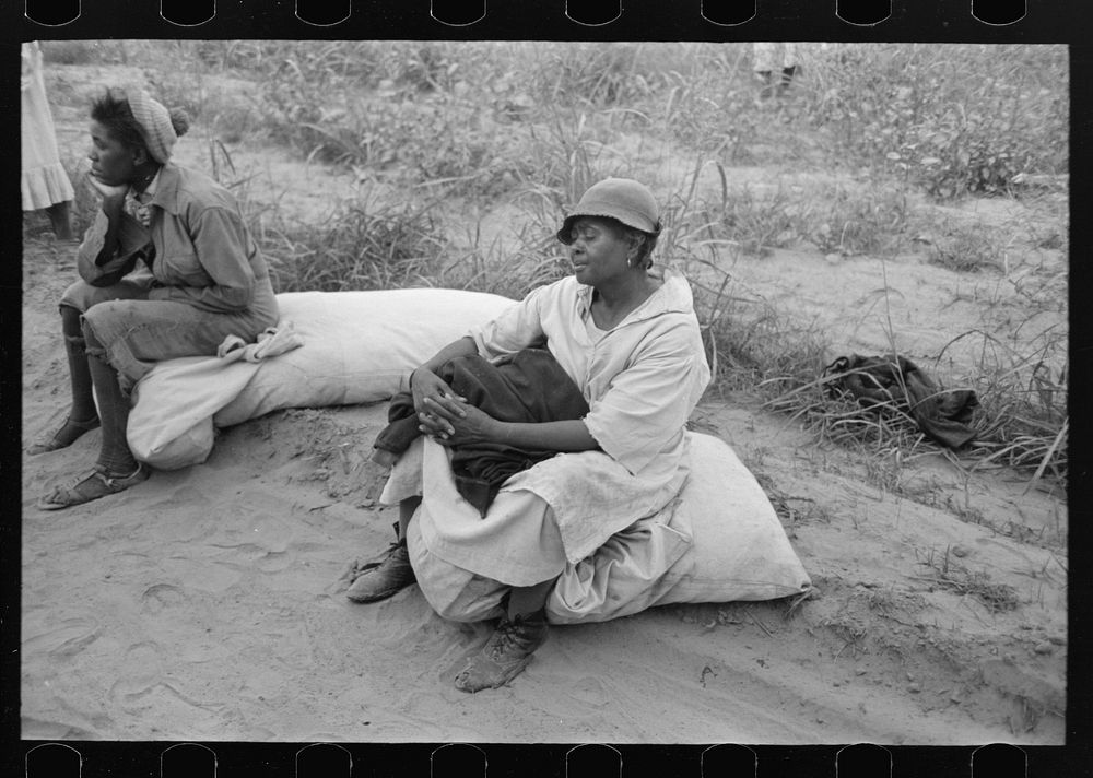 Cotton pickers resting while waiting to be paid. Lake Dick Project, Arkansas by Russell Lee