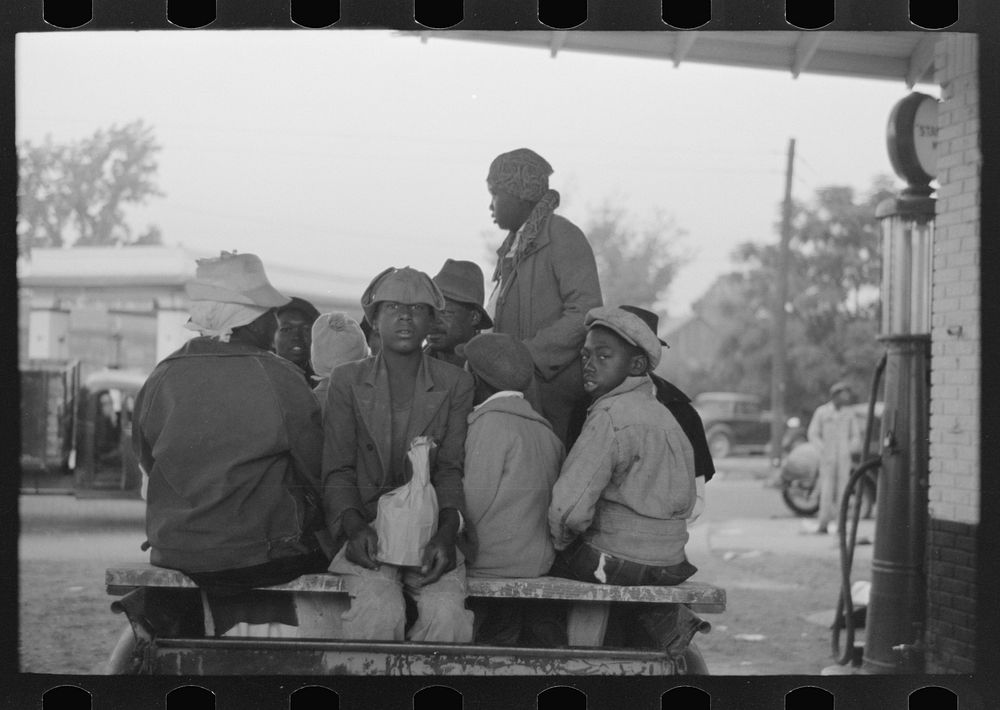 [Untitled photo, possibly related to: Cotton pickers boarding truck which will take them to the fields, Pine Bluff…