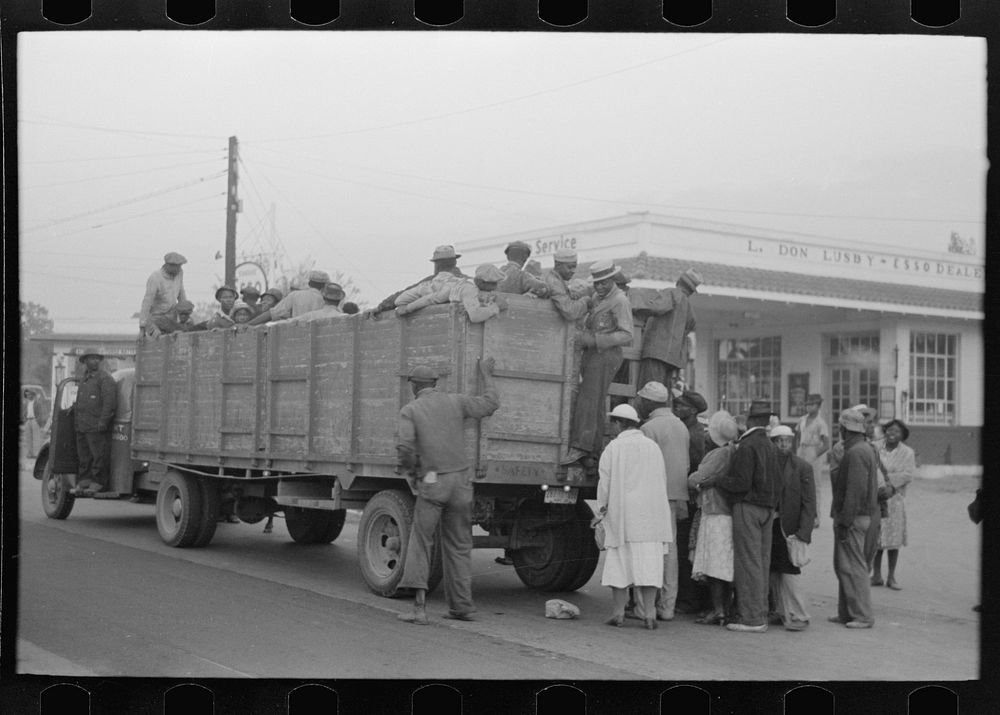 Cotton pickers boarding truck which will take them to the fields, Pine Bluff, Arkansas by Russell Lee