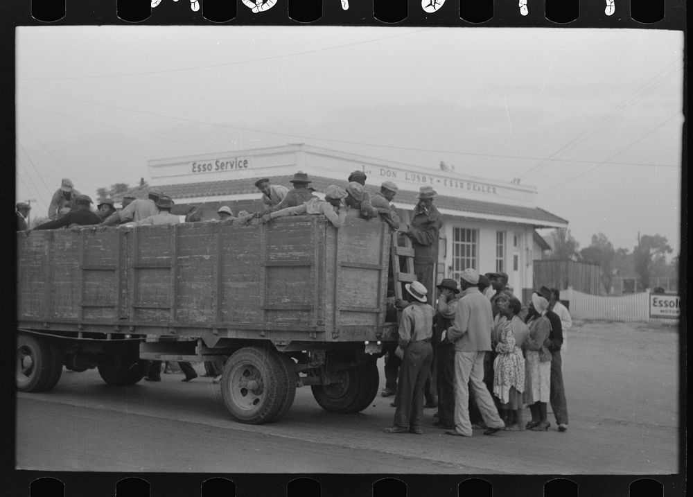 [Untitled photo, possibly related to: Cotton pickers boarding truck which will take them to the fields, Pine Bluff…