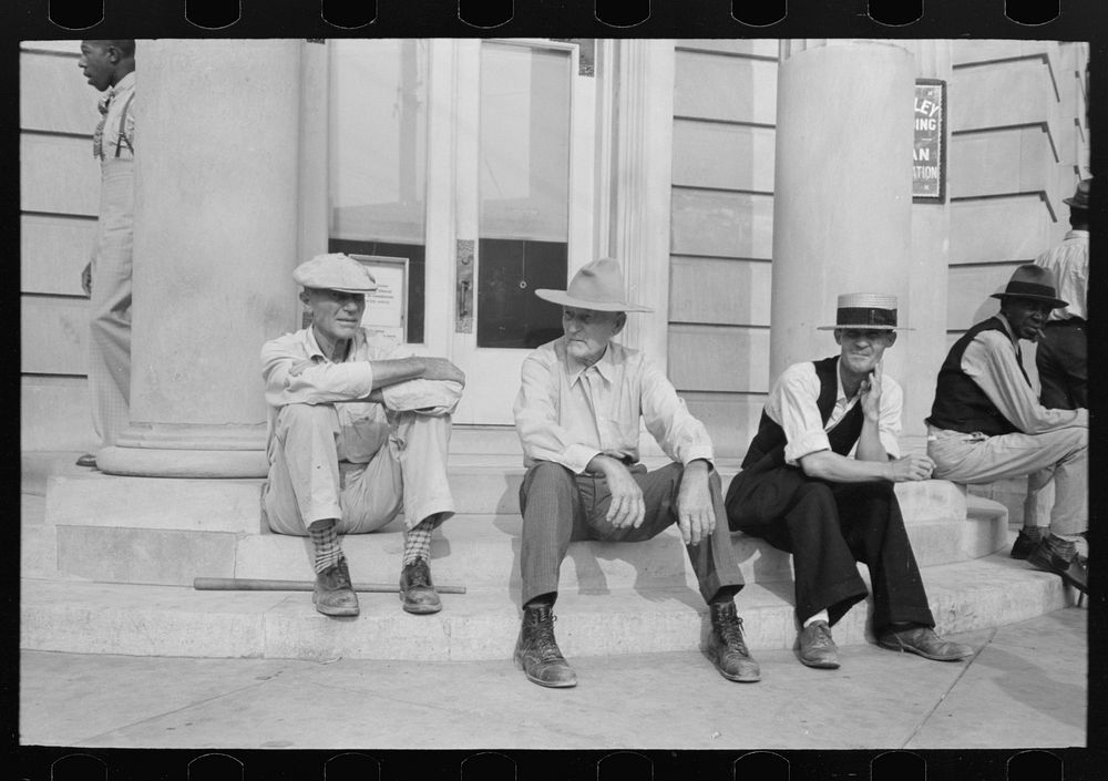 Men sitting on bank steps during National Rice Festival, Crowley, Louisiana by Russell Lee