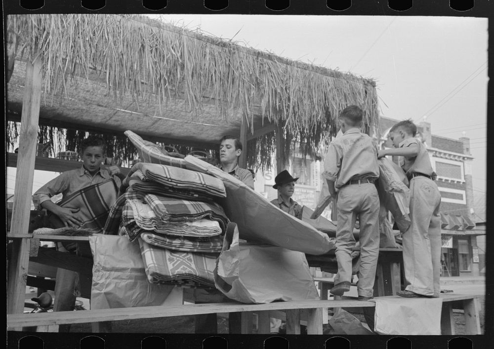[Untitled photo, possibly related to: Arranging prizes to be awarded at game concession, National Rice Festival, Crowley…