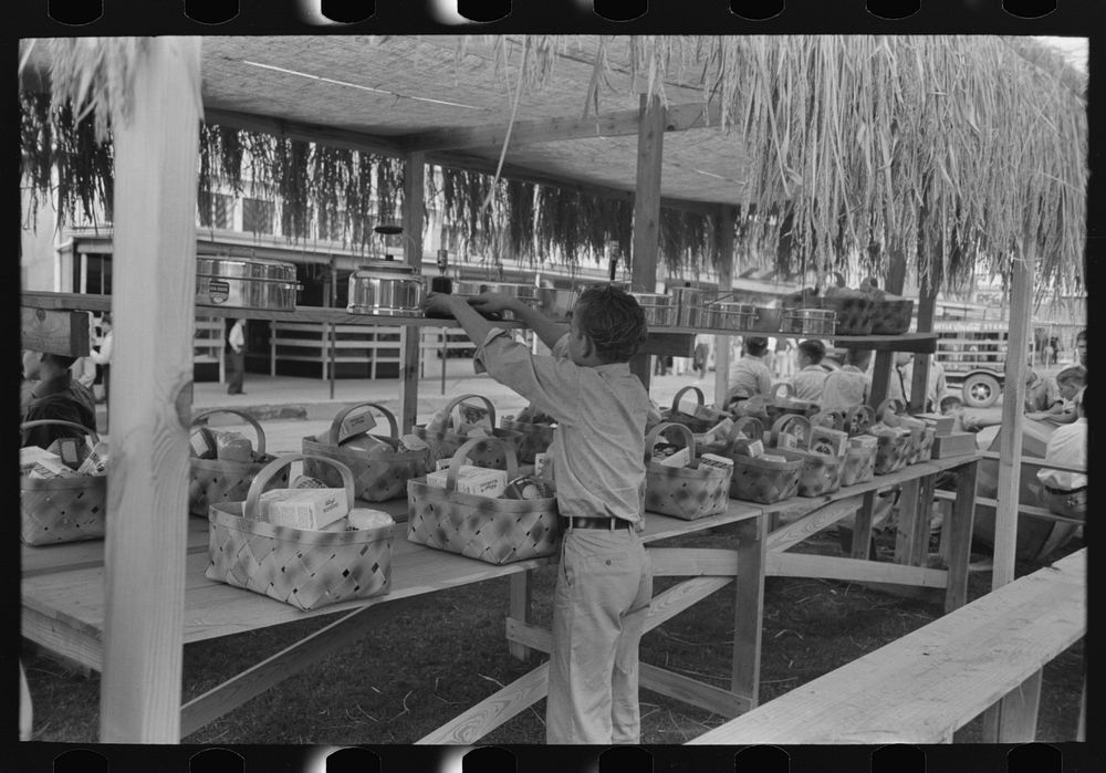 [Untitled photo, possibly related to: Arranging prizes to be awarded at game concession, National Rice Festival, Crowley…