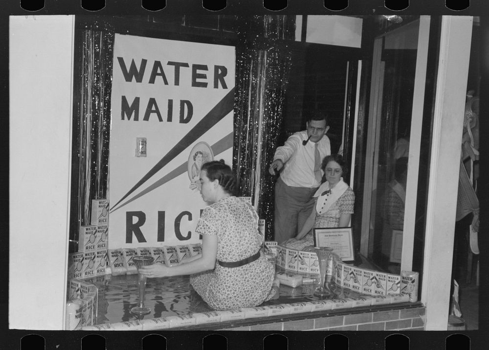Decorating store window for National Rice Festival, Crowley, Louisiana by Russell Lee