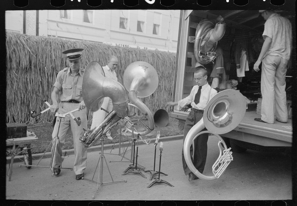 Members of Southwestern University band unloading instruments from truck, National Rice Festival, Crowley, Louisiana by…