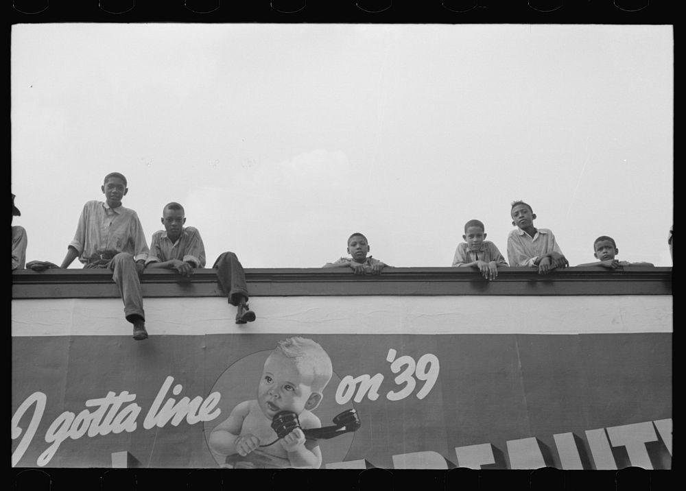 Boys atop billboard, National Rice Festival, Crowley, Louisiana by Russell Lee
