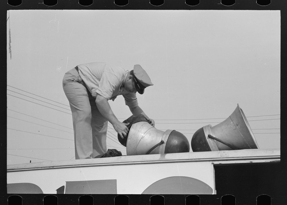 Removing covers from megaphones of public address system, National Rice Festival, Crowley, Louisiana by Russell Lee