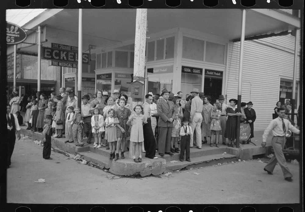 People standing on street corner waiting for parade, National Rice Festival, Crowley, Louisiana by Russell Lee