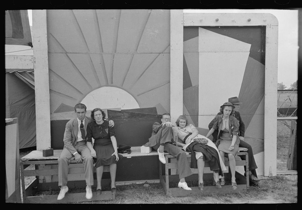 Group of tired people resting at state fair, Donaldsonville, Louisiana by Russell Lee