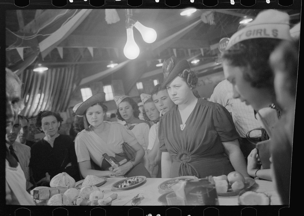 Women watching accomplishments of vegetable shredder at display, state fair, Donaldsonville, Louisiana by Russell Lee