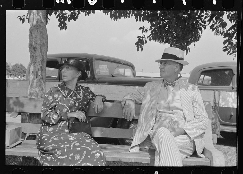 [Untitled photo, possibly related to: Couple sitting on bench, state fair, Donaldsonville, Louisiana] by Russell Lee