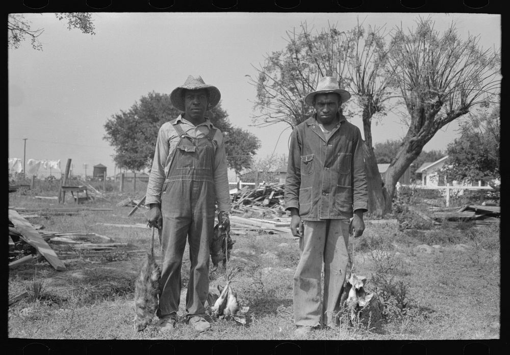 Laborers employed by Joseph La Blanc, wealthy Cajun farmer, Crowley, Louisiana, with possum and birds they shot by Russell…