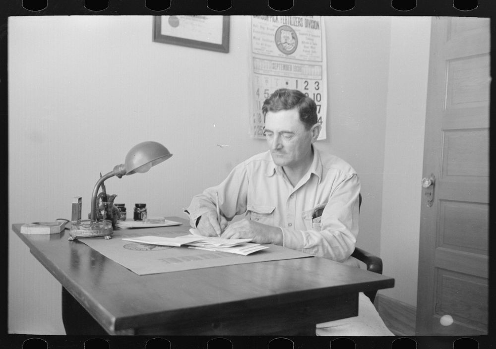 [Untitled photo, possibly related to: Joseph La Blanc at the desk in his office, reading morning mail, near Crowley…