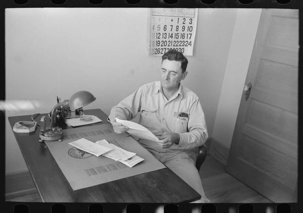 Joseph La Blanc at the desk in his office, reading morning mail, near Crowley, Louisiana by Russell Lee