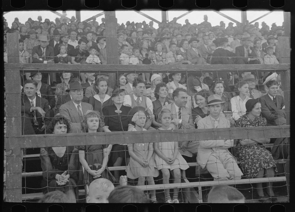 People sitting in the grandstand, watching ceremonies on the main platform, Donaldsonville, Louisiana by Russell Lee