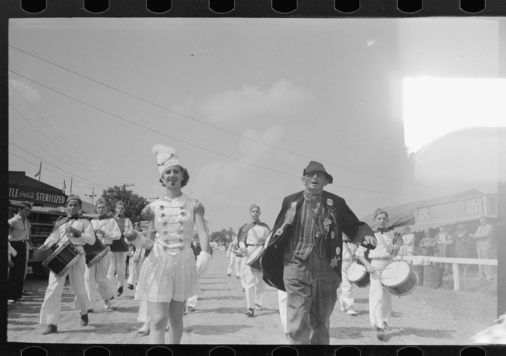 Drum majorette with clown, leading parade of the drum corps, state fair, Donaldsonville, Louisiana by Russell Lee