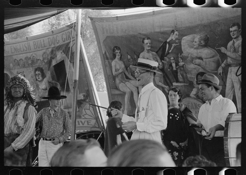 Barker at sideshow with performers, state fair, Donaldsonville, Louisiana by Russell Lee