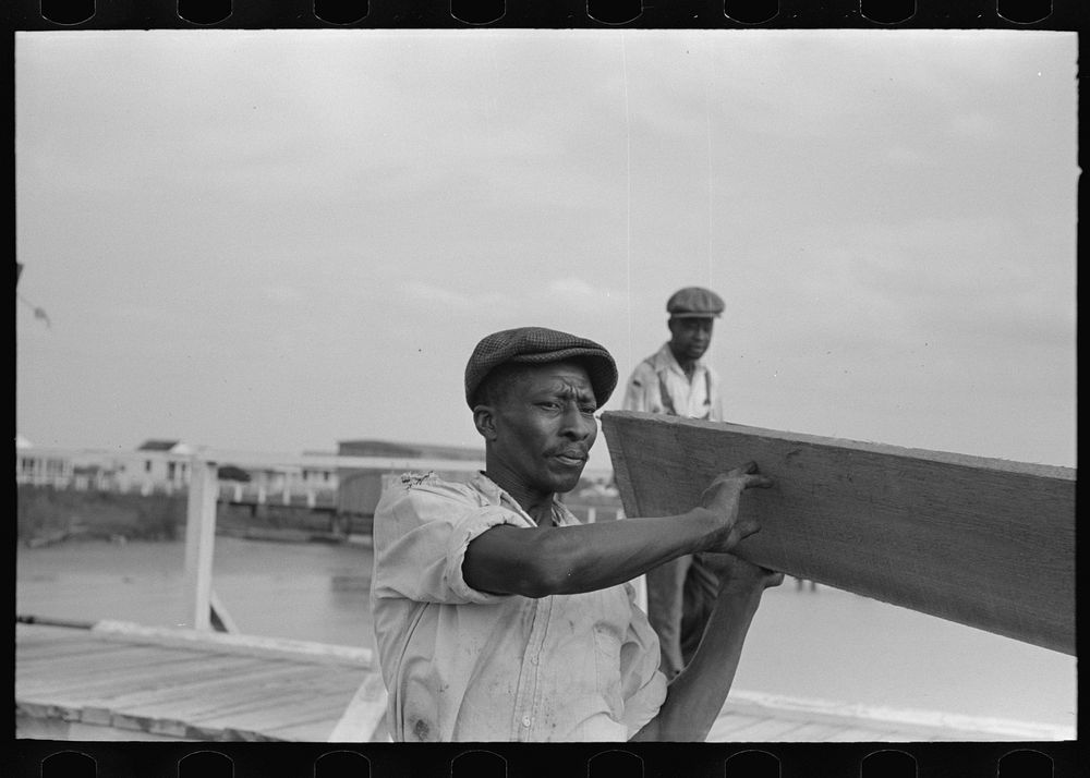  stevedores handling lumber in unloading process, unloading the "El Rito," Pilottown, Louisiana by Russell Lee