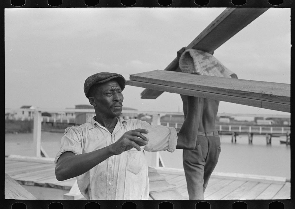  stevedore handling lumber in unloading process, Pilottown, Louisiana, the "El Rito" by Russell Lee