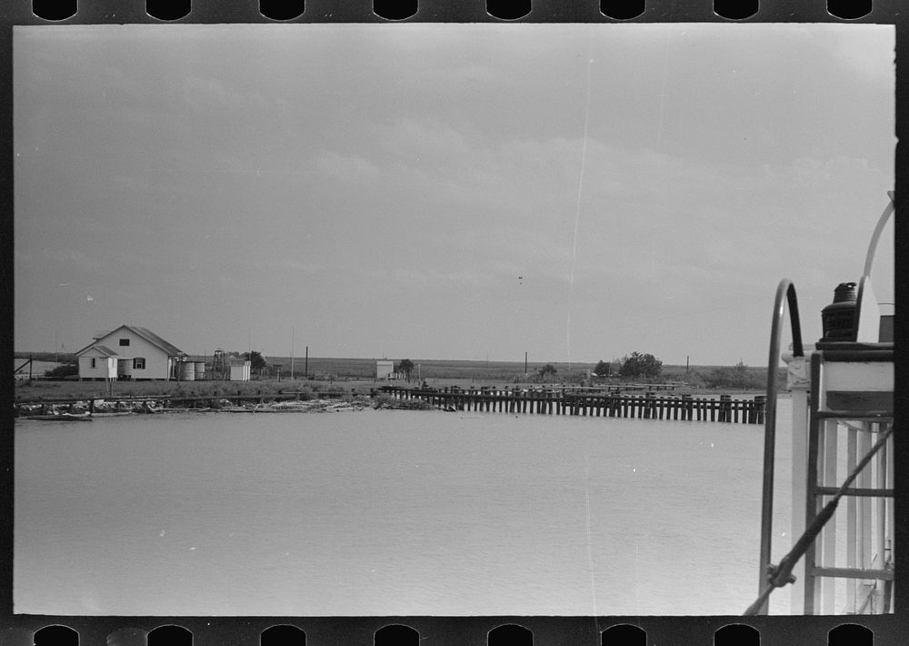 [Untitled photo, possibly related to:  deck hand throwing line in docking operations, Burrwood, Louisiana] by Russell Lee