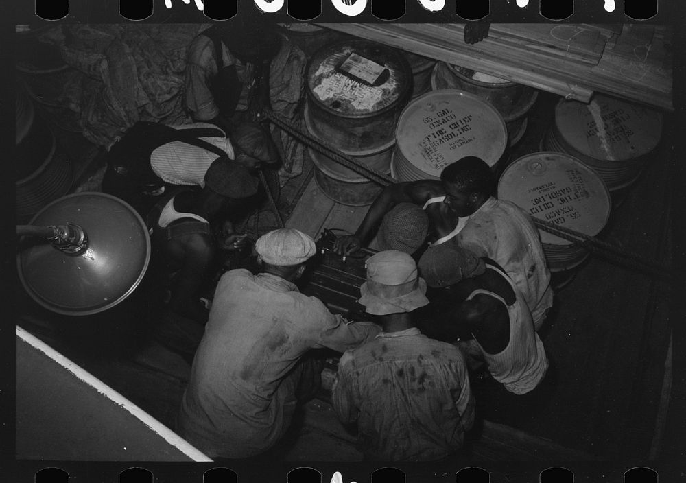 [Untitled photo, possibly related to: Stevedores handling drum, New Orleans, Louisiana] by Russell Lee