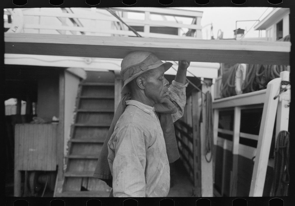  stevedore carrying lumber on his head, New Orleans, Louisiana by Russell Lee