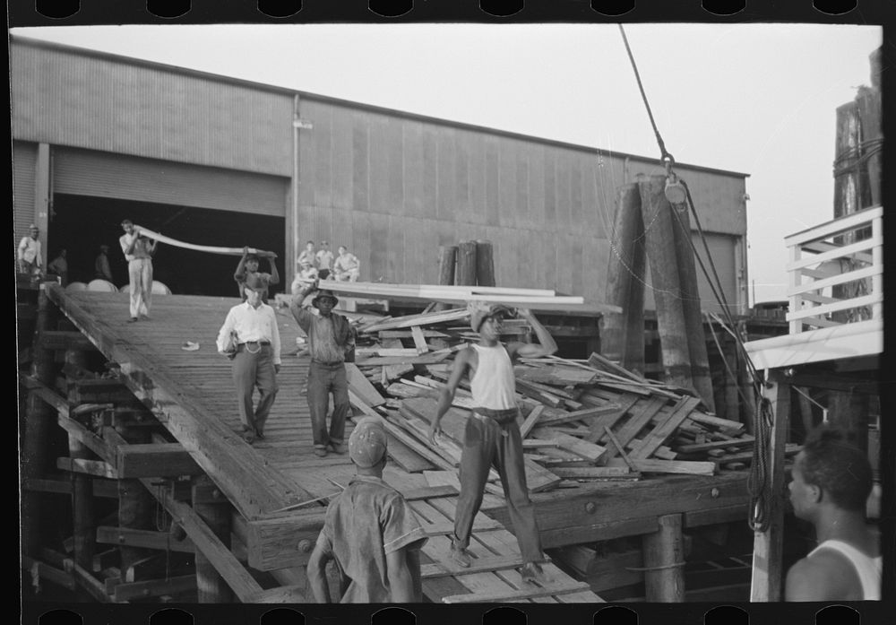 [Untitled photo, possibly related to:  stevedore, with lumber on shoulder, New Orleans, Louisiana] by Russell Lee