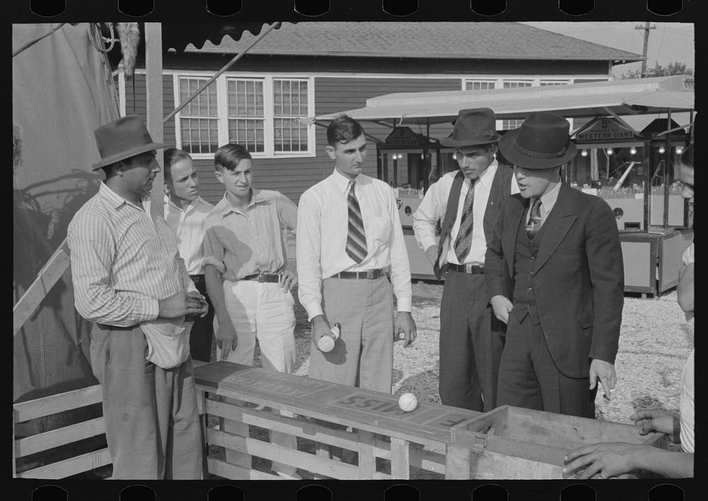 Baseball-throwing concession with man about ready to buy a throw, state fair, Donaldsonville, Louisiana by Russell Lee