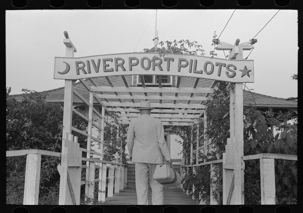 River pilot entering pilot's clubhouse, Pilottown, Louisiana by Russell Lee