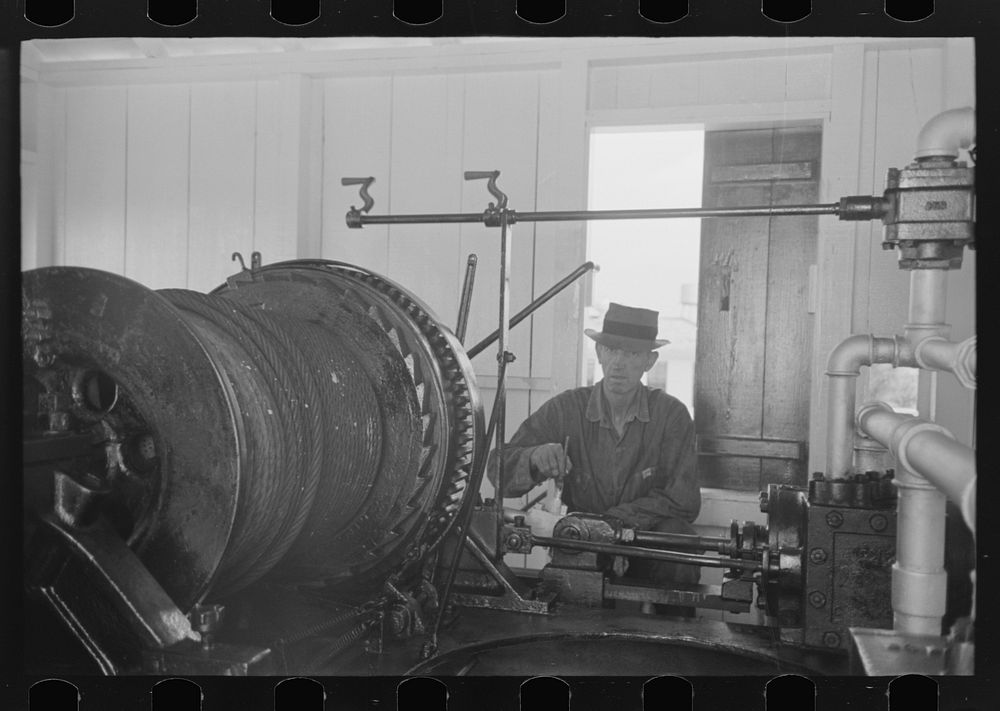 [Untitled photo, possibly related to: Painting elevating winches near Burrwood, Louisiana] by Russell Lee