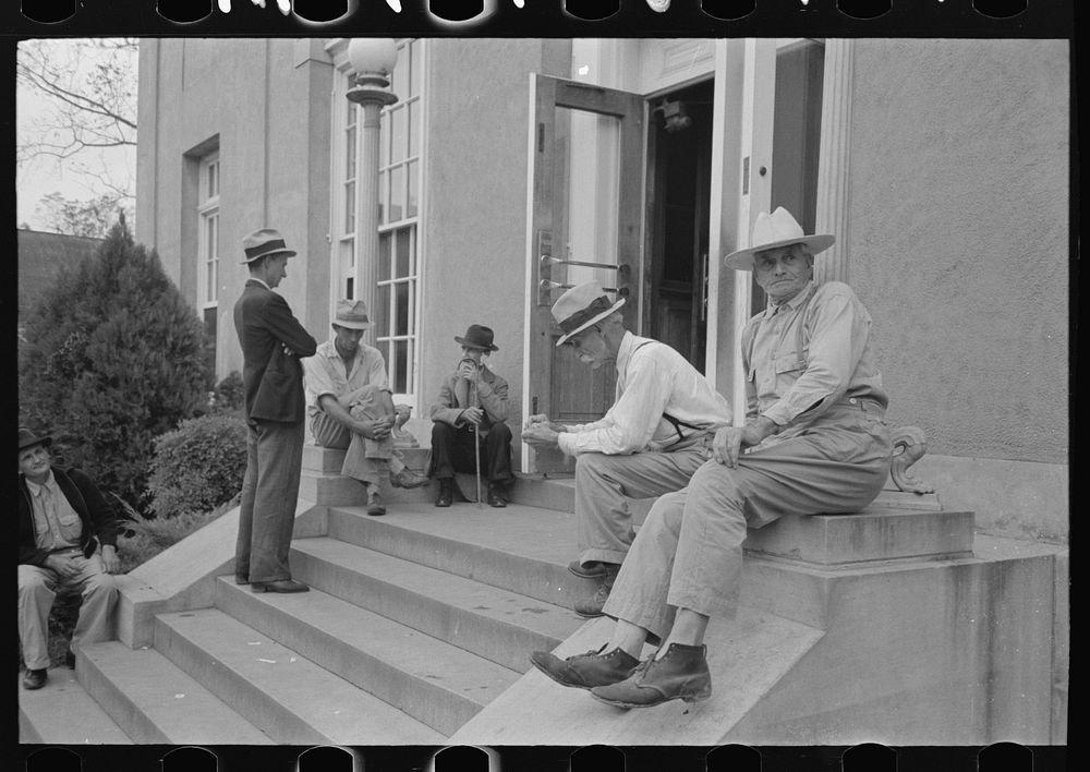 Men sitting on steps of post office, Lafayette, Louisiana by Russell Lee