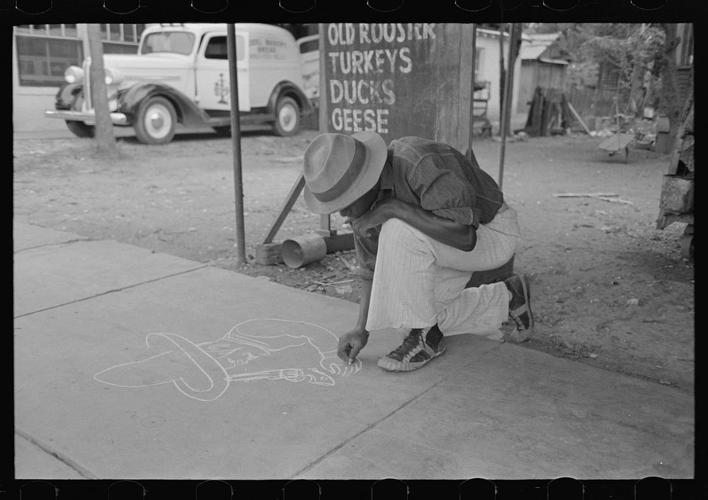 Boy drawing on the sidewalk, New Iberia, Louisiana by Russell Lee