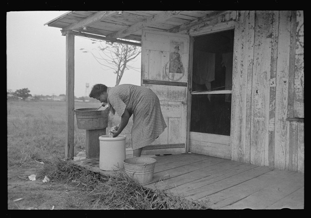 [Untitled photo, possibly related to: es talking on porch of small store near Jeanerette, Louisiana] by Russell Lee