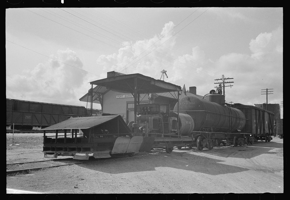 [Untitled photo, possibly related to: Railroad weed burner being fueled, Port Barre, Louisiana] by Russell Lee