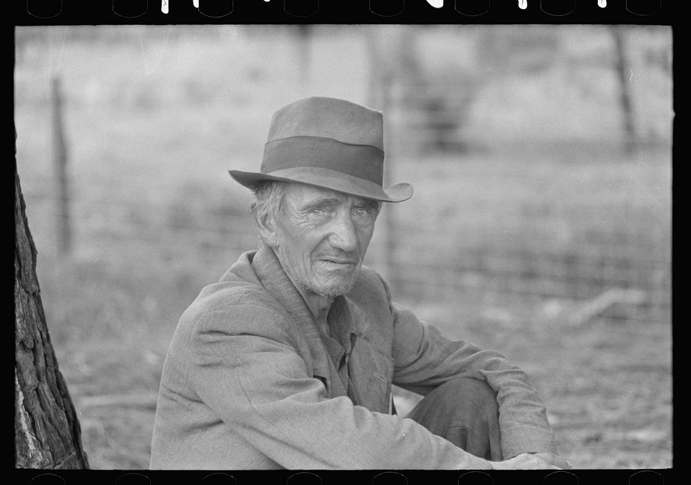Migrant worker resting along roadside, Hancock County, Mississippi by Russell Lee
