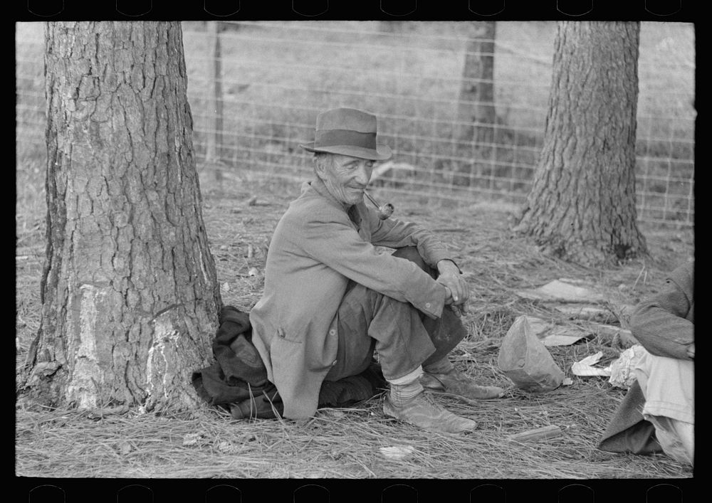 Migrant worker resting at roadside, Hancock County, Mississippi by Russell Lee