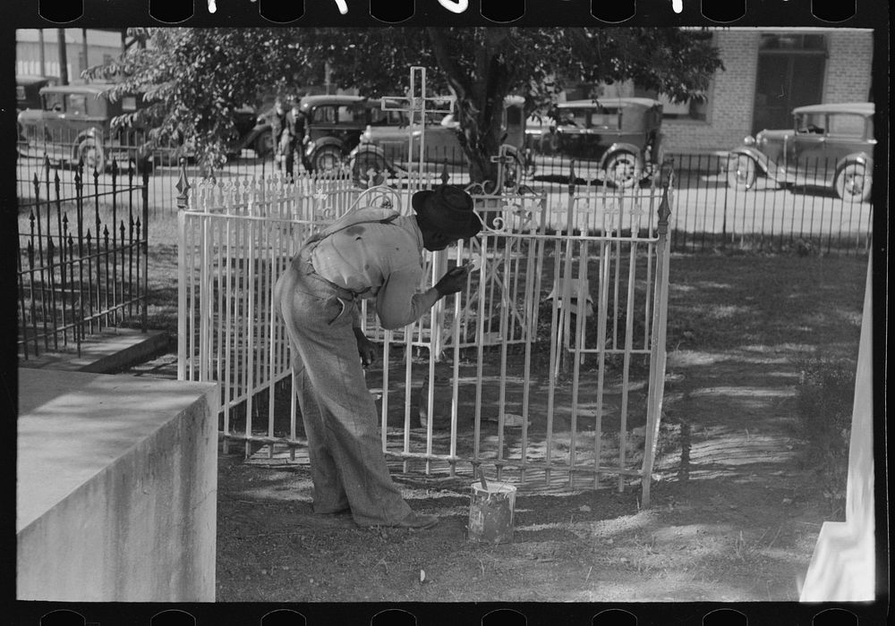 On All Saints' Day it is customary in Louisiana for fences to be painted and whitewashed. New Roads, Louisiana by Russell Lee