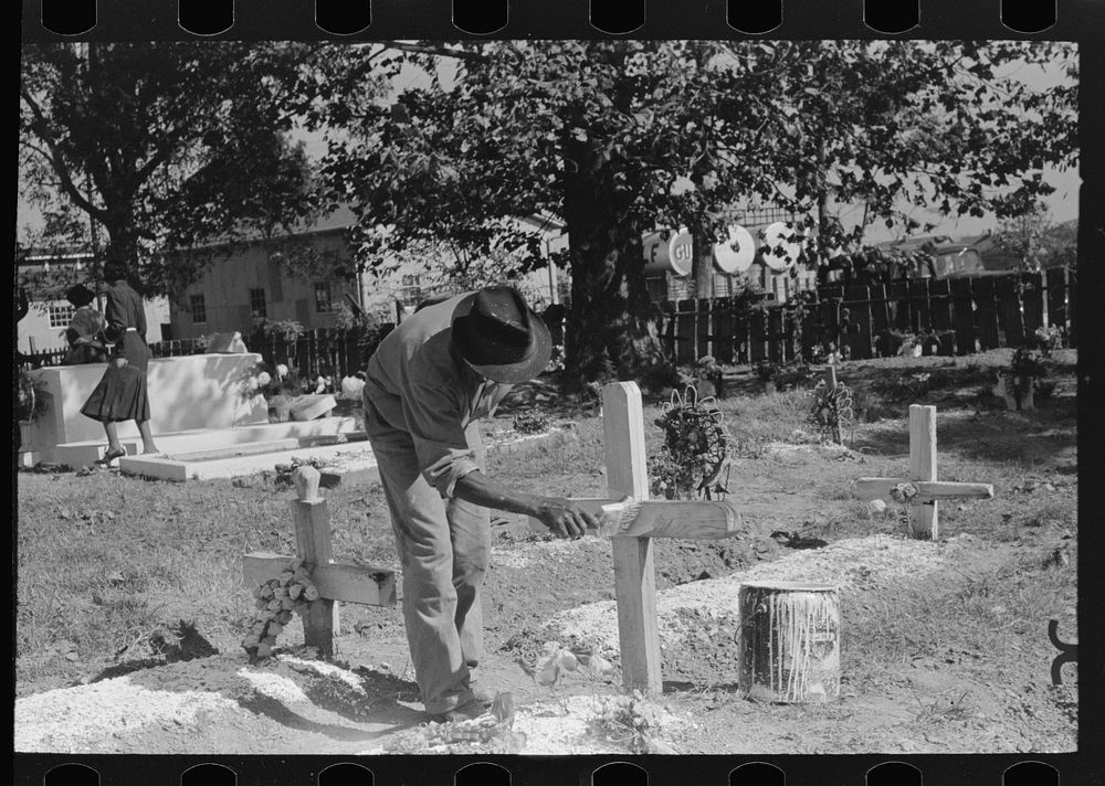 Painting grave marker in cemetery, All Saints' Day in New Roads, Louisiana by Russell Lee