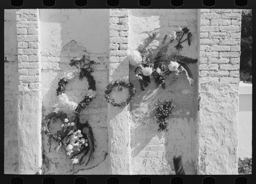 [Untitled photo, possibly related to: Decorations on side of family burial vault in cemetery at New Roads, Louisiana on All…